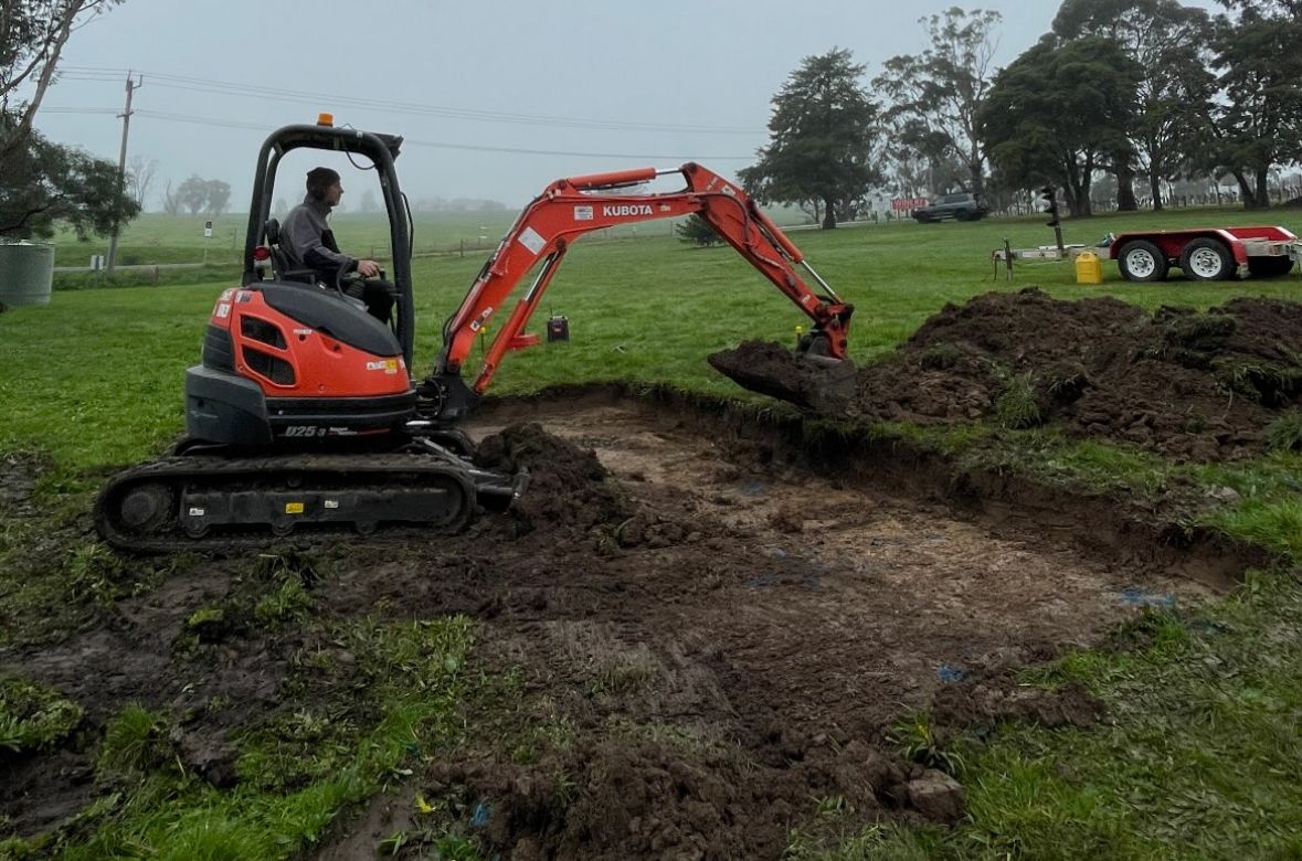 The builder cutting a site for a pergola, Chirnside Park